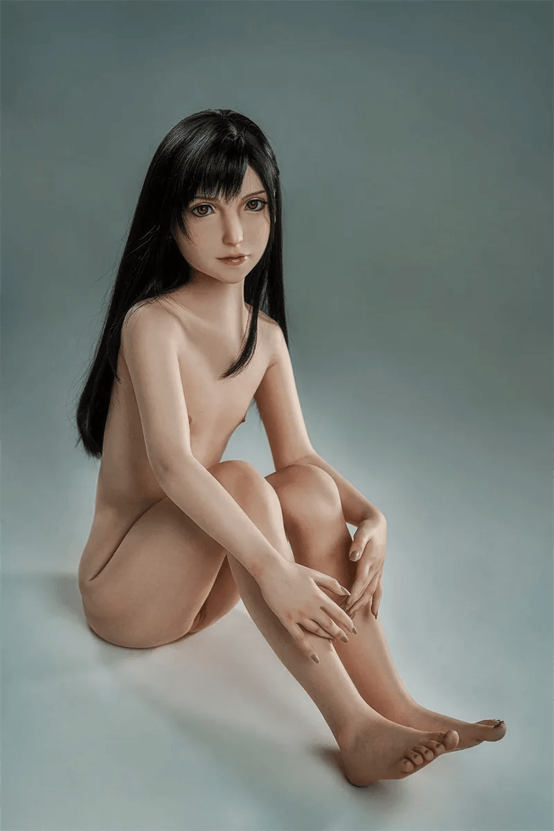 Mizuki sitzt auf dem Boden, seitlich sichtbar. Elegante Silhouette und entspannte gestreckte Beine.